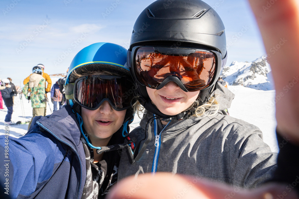 Boys wearing ski helmet and taking selfie on sunny day Boys wearing ski helmet and taking selfie on sunny day