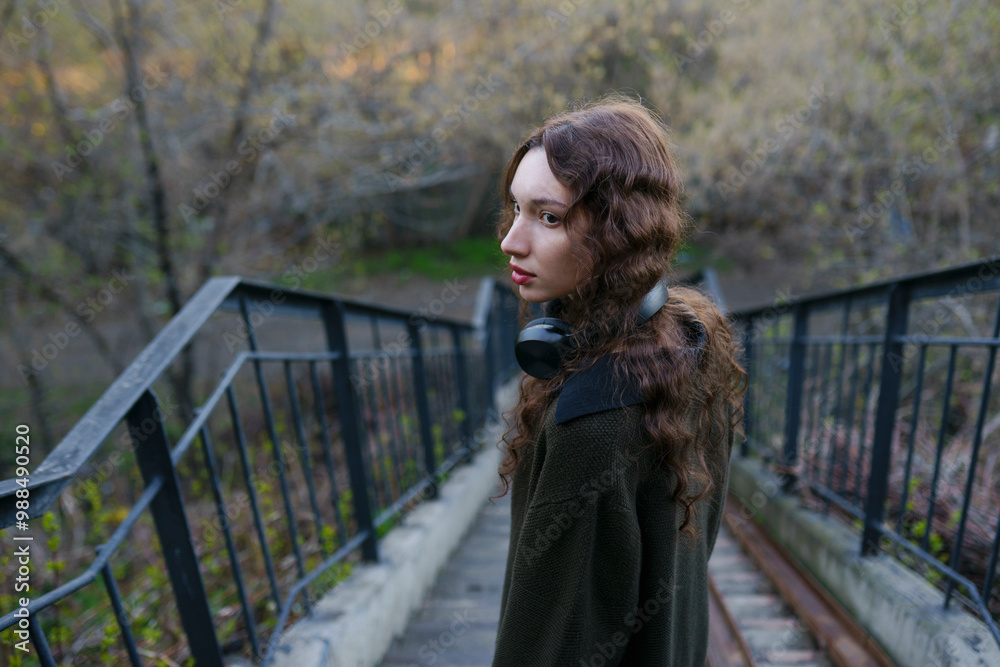 Young woman standing near staircase