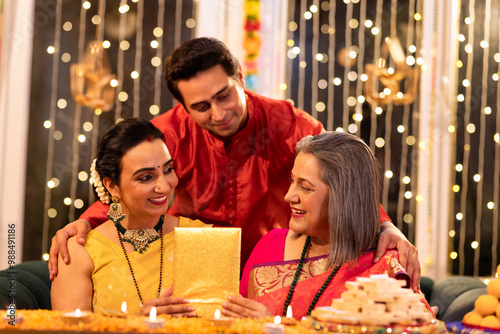 Two generation family celebrating Diwali festival at home photo