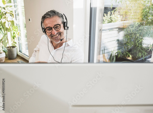 Smiling sales representative working at home office photo