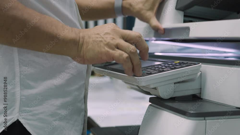 Close up, Hand of man press buttons on photocopier machine to copy or scanning document in office.Businessman copy document at workplace. Businessman working in Office.