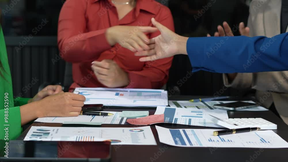 Happy businessman and businesswoman shaking hands at group board meeting. Happy businessman and businesswoman shaking hands at group board meeting.