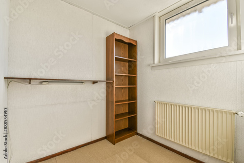 Empty room with wooden bookshelf and natural light photo