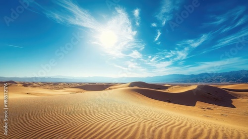 A remote desert landscape with rolling sand dunes stretching out under the bright sun, casting long shadows across the ground.