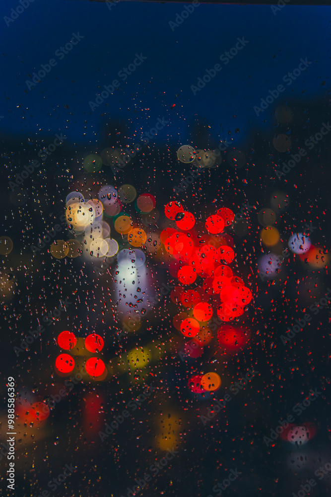 rain drops on window surface with colorful traffic bokeh light in background rain drops on window surface with colorful traffic bokeh light in background