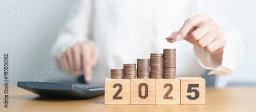 Happy New Year 2025 with Coins stack and calculator. Money, Budget, tax, investment, financial, savings and New Year Resolution concepts photo