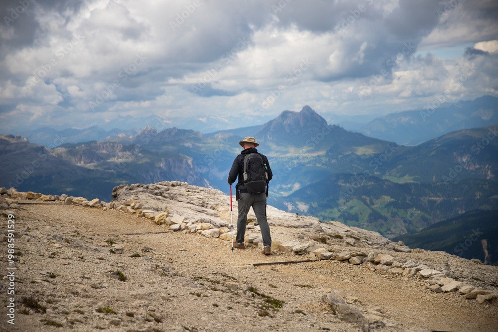 Hiker enjoys the view from Lagazuoi mountain over the italian Dolomites. Hiker enjoys the view from Lagazuoi mountain over the italian Dolomites.