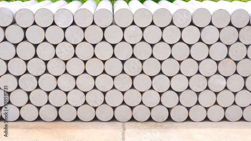 Concrete cylinder micropile background. Pile of many precast spun micropiles construction material stacked on the floor in industry yard area for building foundation work photo