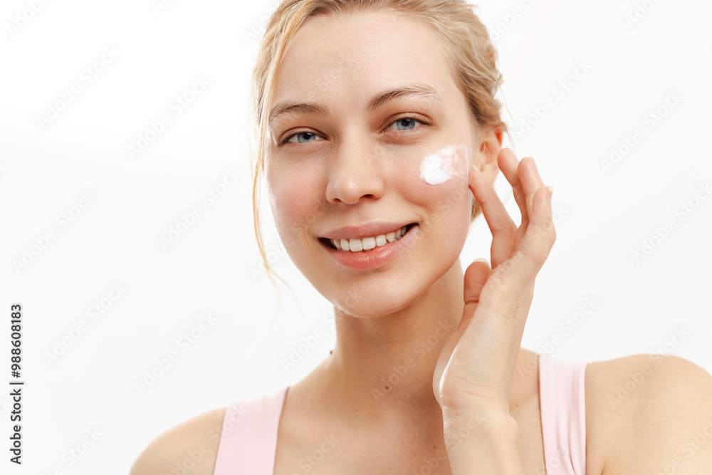 Smiling woman applying cream on her face, protection. Cream protects skin from photoaging and harmful effects ultraviolet rays. Smiling woman applying cream on her face, protection. Cream protects skin from photoaging and harmful effects ultraviolet rays.