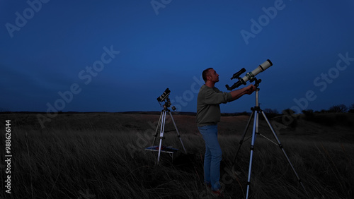 Wallpaper Mural Amateur astronomer looking at the evening skies, observing planets, stars, Moon and other celestial objects with a telescope. Torontodigital.ca