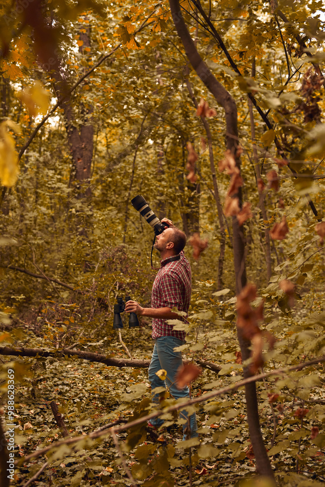 Man using binoculars and camera for bird and animal watching in nature. Man using binoculars and camera for bird and animal watching in nature.