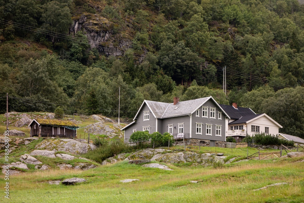 Green wooden building and barns in Norwegian landscape Green wooden building and barns in Norwegian landscape