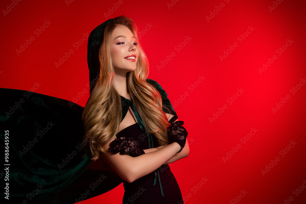 Photo of pretty smiling lady in witch costume cross arms look red background place for halloween ads