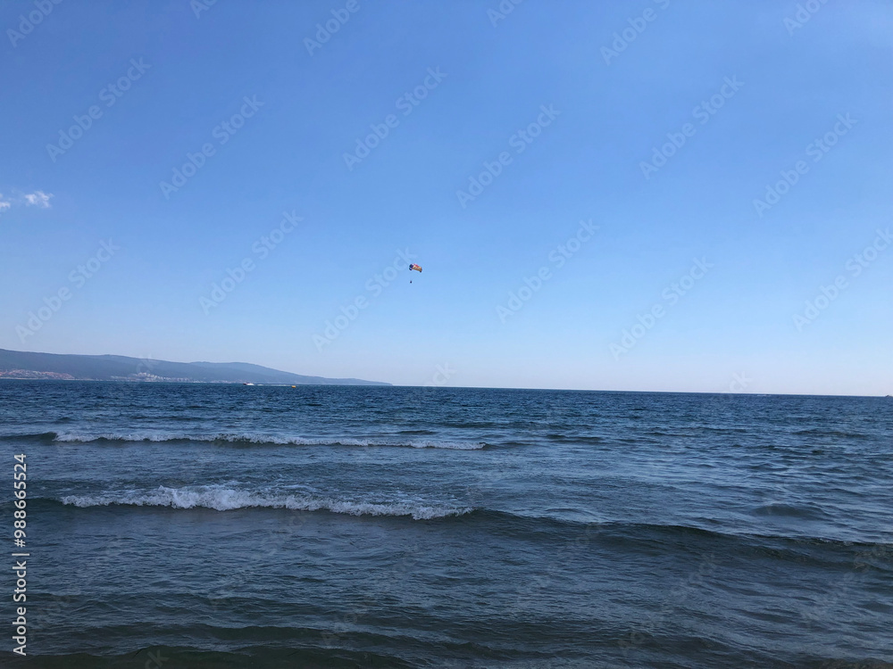 Parachutist in the sky above the sea. Extreme sports and recreation. Parachutist in the sky above the sea. Extreme sports and recreation.