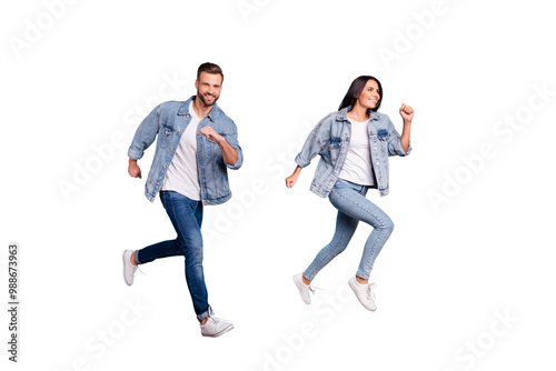 Full length body size photo of beautiful charming gorgeous turned couple with groom fiance running after fiancee while isolated with blue background photo