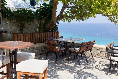 table and chairs on the  restaurant with sea view in Afytos on the Kassandra-Chalkidiki peninsula - Greece photo