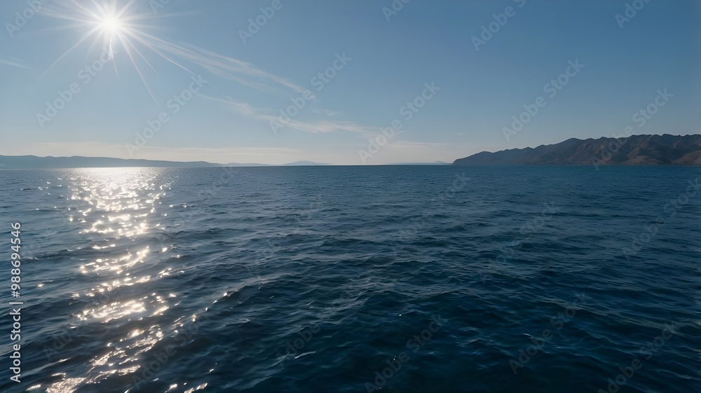 Obraz premium Blue ocean water beneath a clear blue sky, showcasing crystal-clear water on a beautiful summer day with soft waves