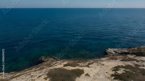 Blue ocean water under a clear blue sky, highlighting crystal-clear water on a beautiful summer day with gentle waves