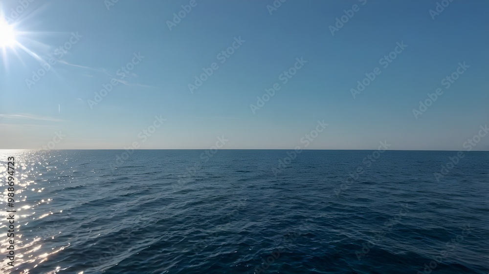 Fototapeta premium Blue ocean water with a clear blue sky, clear water, sea, beautiful summer day with calm waves