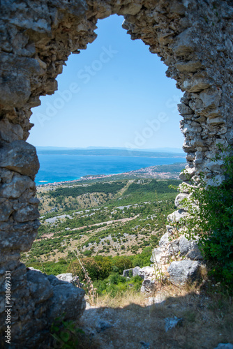 Novi Vinodolski as seen from vidikovac Gradina, through a ruins of an old settlement photo