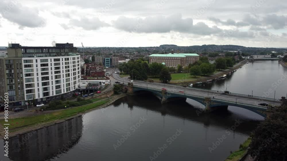 Drone video slides sideways across the River Trent by London Road bridge in Nottingham while cars cross on a cloudy summers day. Drone video slides sideways across the River Trent by London Road bridge in Nottingham while cars cross on a cloudy summers day.
