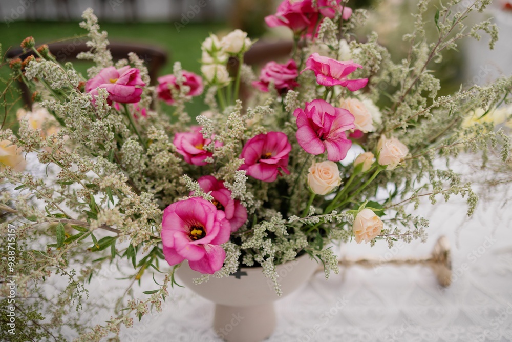 Elegant flower arrangement with pink and peach flowers in a white vase. Elegant flower arrangement with pink and peach flowers in a white vase.