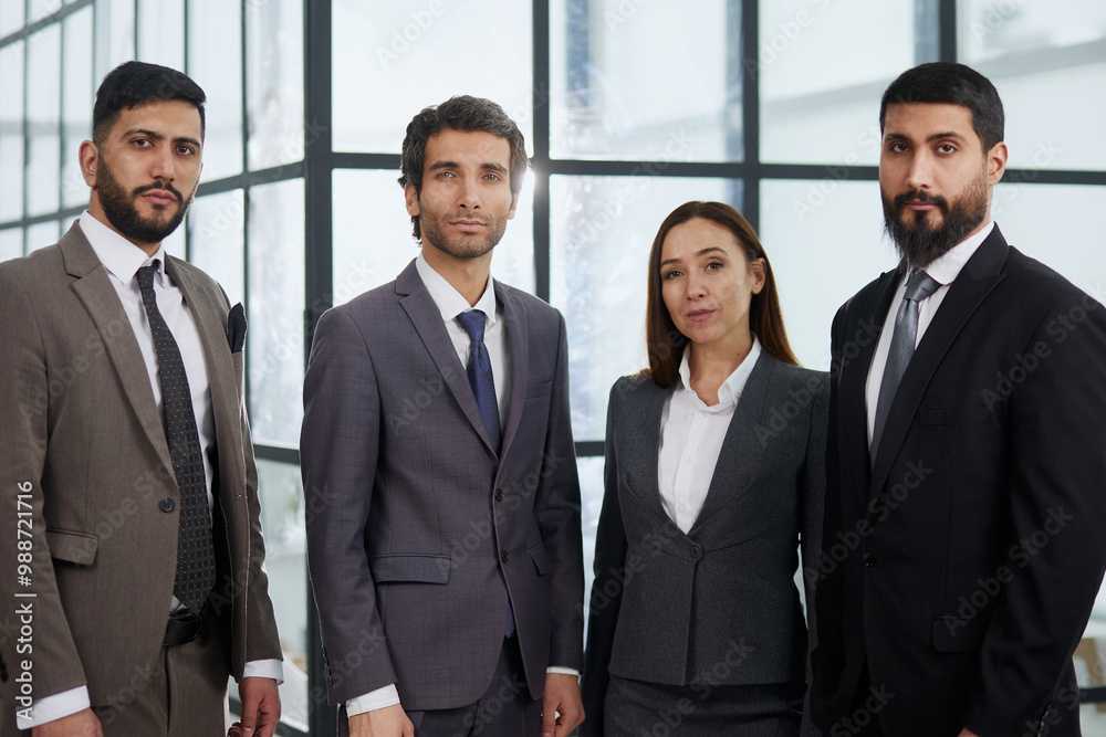 A group of business workers look seriously and confidently at the camera. A group of business workers look seriously and confidently at the camera.