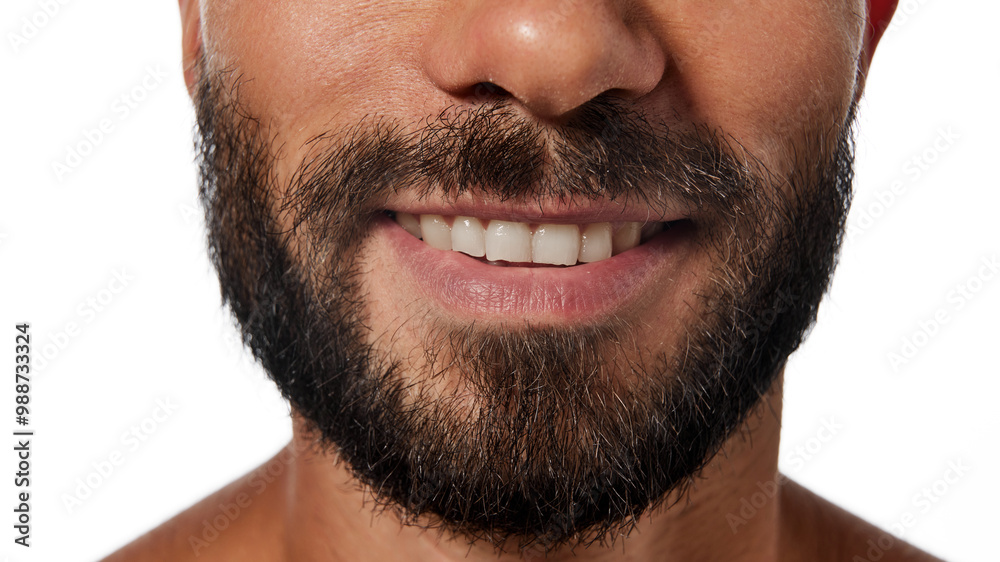 Obraz premium Cropped image of male jaw, bearded face, lips, nose isolated on white studio background. Smiling, Teeth whitening, beard grooming. Concept of male beauty, skin care, hygiene