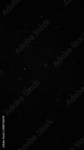 vertical footage of flying dust black background