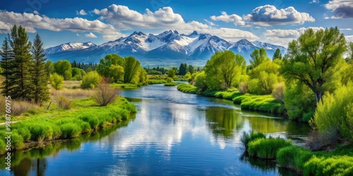 The river flows tranquilly, surrounded by lush greenery and snow-capped mountains in the picturesque town of Rexburg, Idaho.