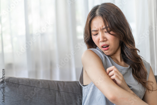 Asian woman with a disgusted expression touching her arm, feeling discomfort or itchiness on a sofa, health and skin irritation issue, unpleasant feeling, young female showing reaction of sensitivity Free Download Asian woman with a disgusted expression touching her arm, feeling discomfort or itchiness on a sofa, health and skin irritation issue, unpleasant feeling, young female showing reaction of sensitivity - GFXLoad