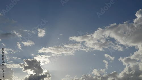 timelapse of the artistic movement of clouds as the sun behind them creates mystical lighting effects