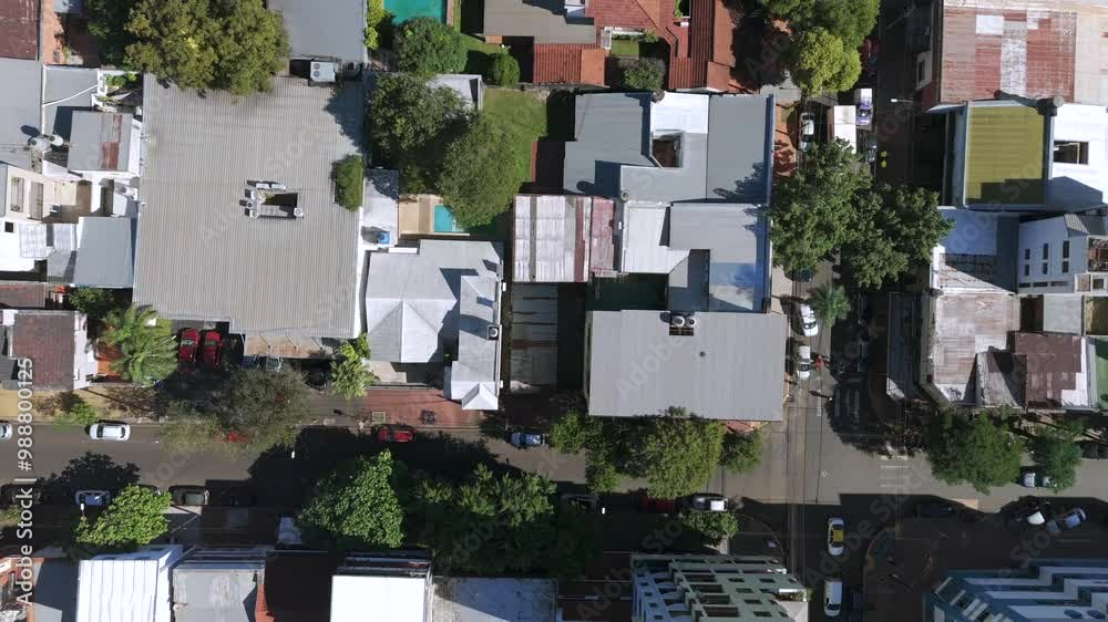 Aerial overhead footage capturing a residential neighborhood in posadas, misiones, argentina, showcasing houses, trees, and streets from above on a sunny day
