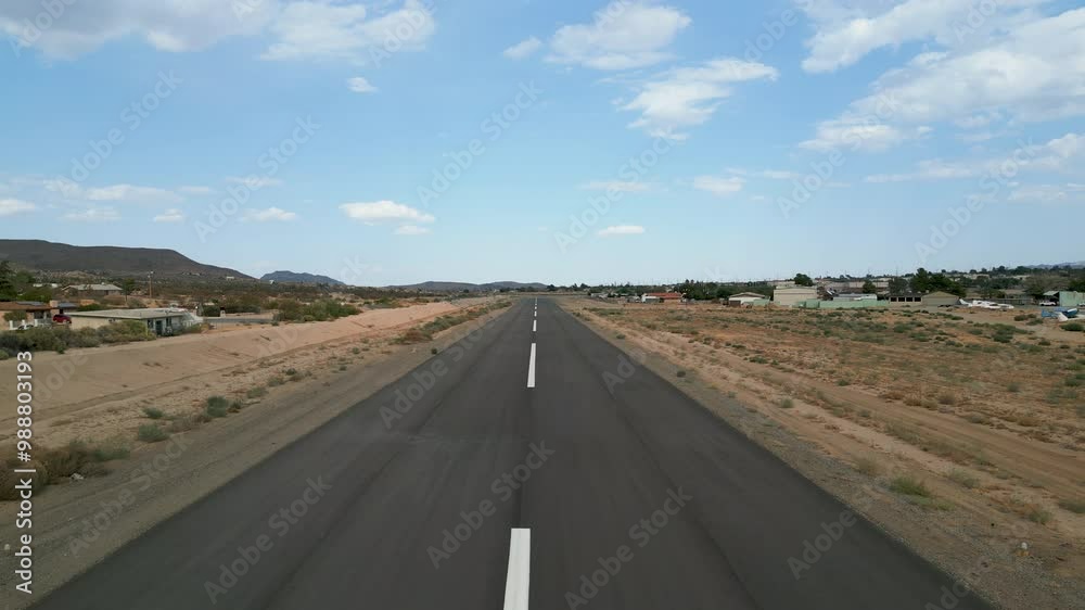 Aerial drone shot traveling down the runway at a small general aviation airport Aerial drone shot traveling down the runway at a small general aviation airport