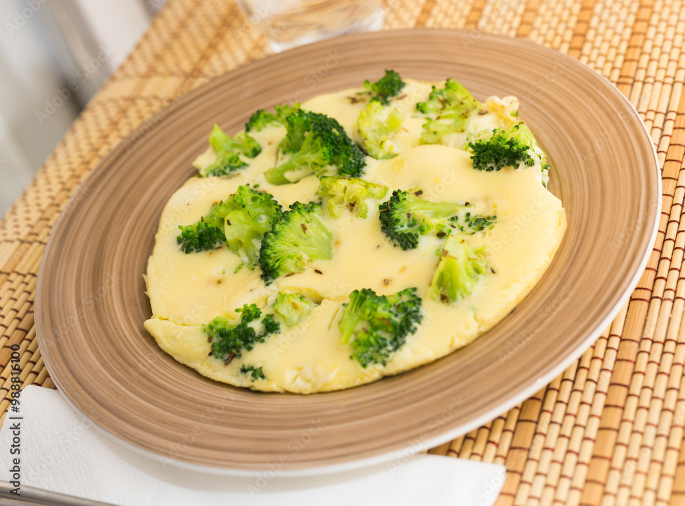 Wholesome breakfast. omelet with broccoli on brown plate Wholesome breakfast. omelet with broccoli on brown plate
