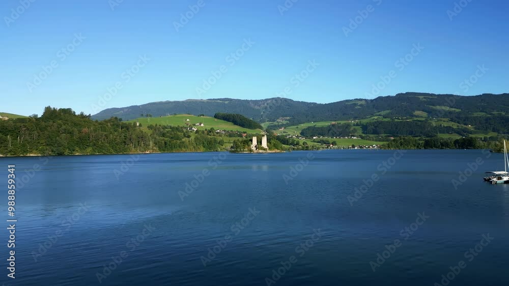 Slow push in drone shot of Ogoz Island on Lake of Gruyère in Canton of Fribourg in Switzerland. Slow push in drone shot of Ogoz Island on Lake of Gruyère in Canton of Fribourg in Switzerland.