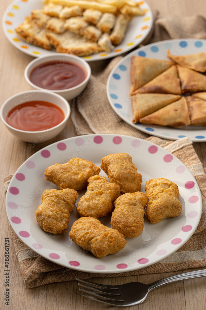 Golden Chicken Nuggets and Tasty Sides on a Table Golden Chicken Nuggets and Tasty Sides on a Table
