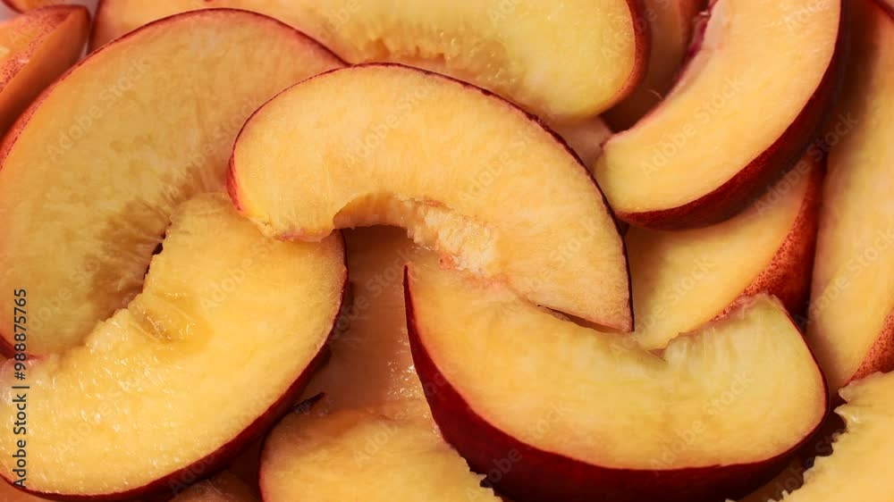 Bright orange and red peach slices circle rotation close up top view Bright orange and red peach slices circle rotation close up top view