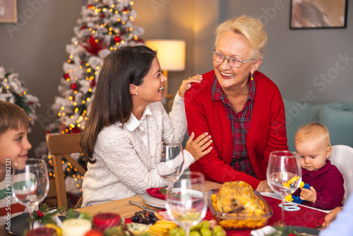 Senior woman celebrating Christmas with daughter and grandchildren