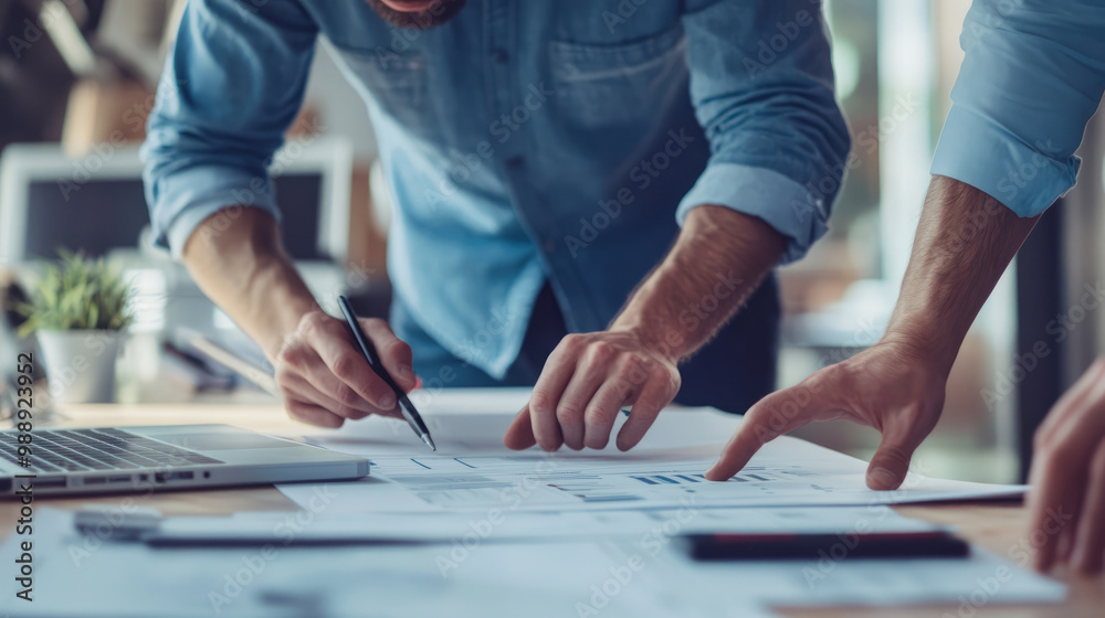 Engineers working on refining the technical specifications of a new product Engineers working on refining the technical specifications of a new product