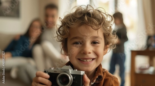 Child holding camera, proudly showing off the photos they've taken to their parents