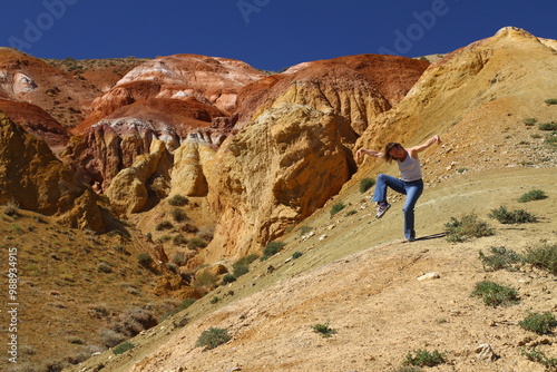 Tourists pose against the background of Martian landscapes – a red deserted area with canyons. 