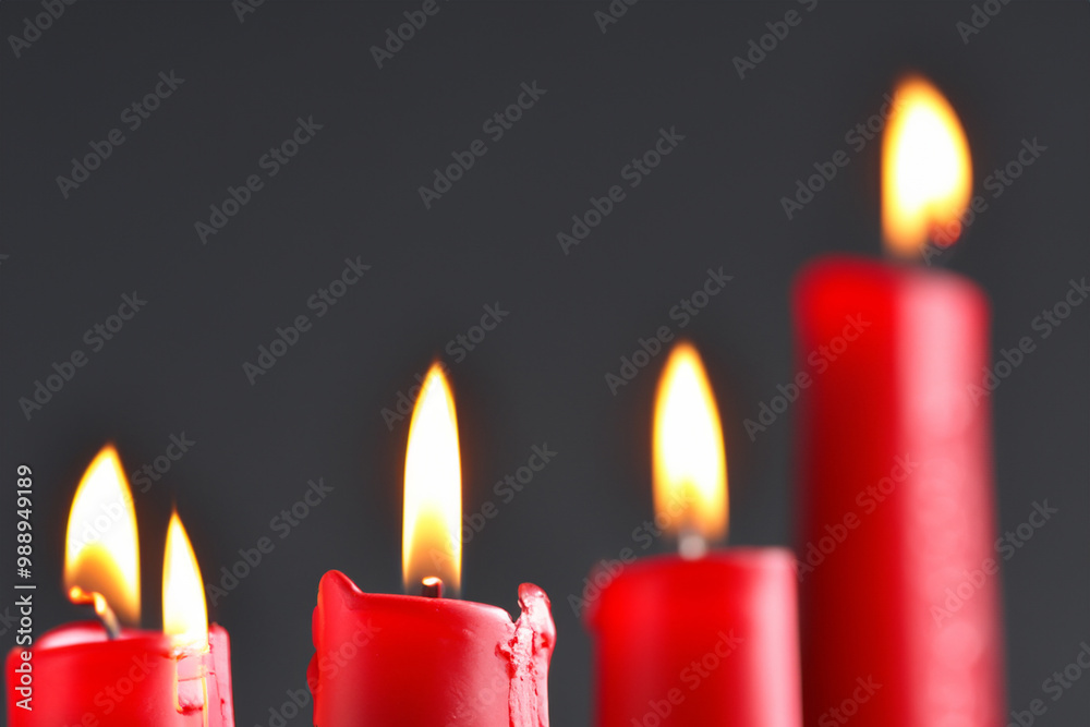 Candle in red and gray on a . ation colorful gift concept. a small candle burning in a dark gray . small candles burning in a dark of lifestyle gray and red. Candle in red and gray on a . ation colorful gift concept. a small candle burning in a dark gray . small candles burning in a dark of lifestyle gray and red.