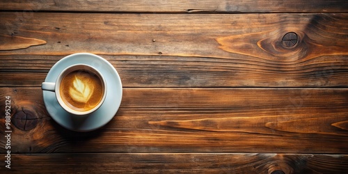 Top view of a coffee cup placed on a wooden table, perfect for cozy and relaxing vibes