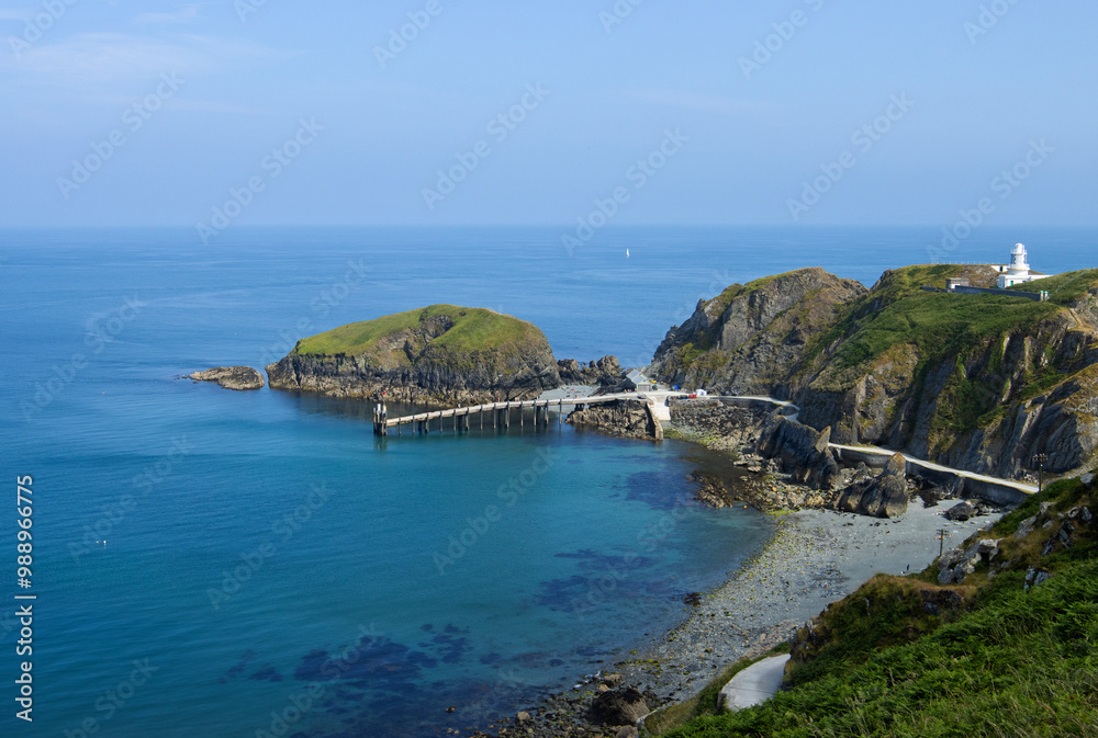 Elevated view of the landing bay of the Lundy Island and Lundy South Lighthouse in the Bristol Channel in tranquil day