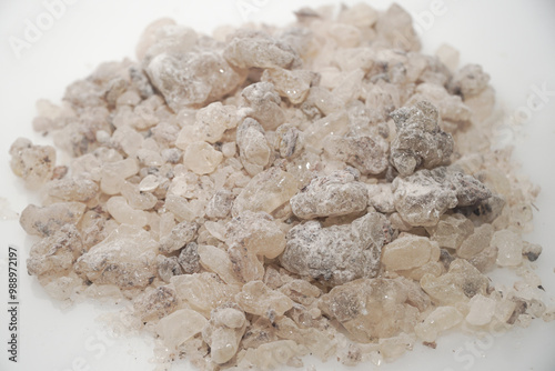 Aromatic heap of Damar Mata Kucing (Shorea Javanica) resin gum copal grade, also known as Dammar gum, isolated on a clean white background.