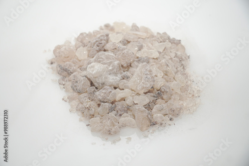Aromatic heap of Damar Mata Kucing (Shorea Javanica) resin gum copal grade, also known as Dammar gum, isolated on a clean white background.