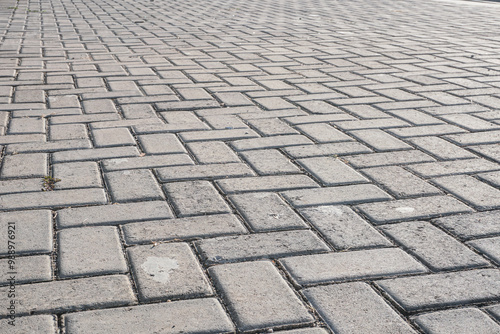 A close-up image of a brick pavement, showcasing the intricate pattern and texture of the bricks. Ideal for design projects, backgrounds, or construction-related content.