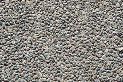 A high-resolution image of a seamless texture of small grey pebbles embedded in concrete. Perfect for backgrounds, website designs, and print projects.