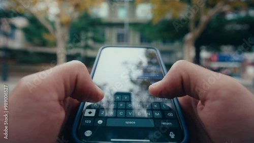 POV shot of man typing on smartphone keyboarn outduurs in city, close up shot
